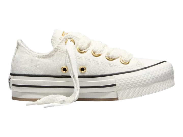 Tenis Converse Chuck Taylor All Star blancos de plataforma con ojillos dorados y suela gruesa.