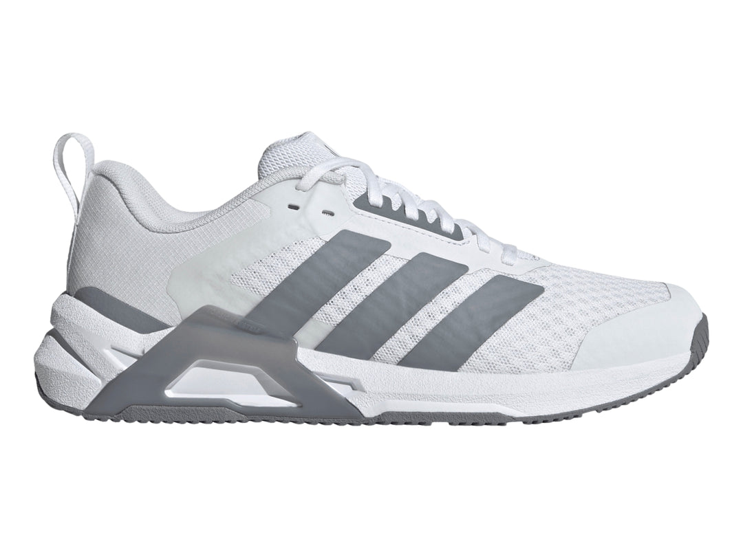 Tenis Adidas Dropset Control Tra color blanco con franjas laterales y suela en gris.