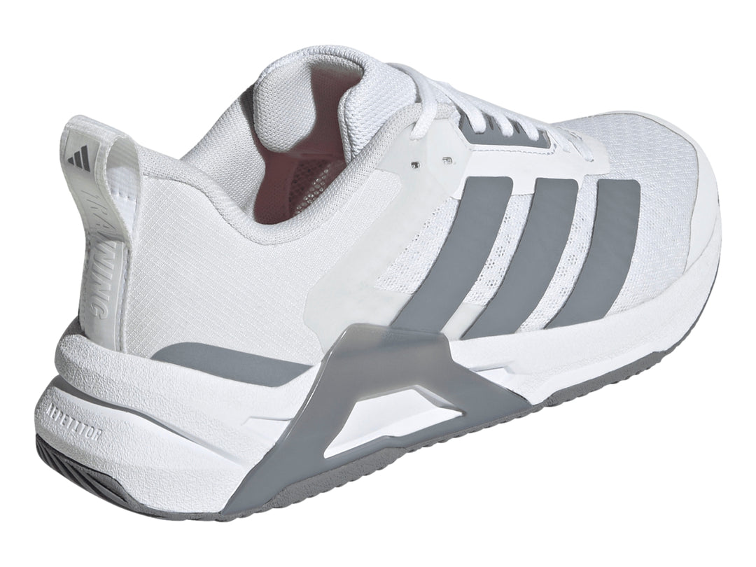 Tenis Adidas Dropset Control Tra color blanco con franjas laterales y suela en gris.