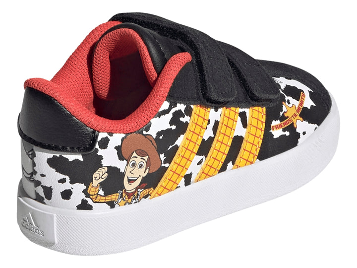 Tenis Adidas negros con estampado de vaca, rayas amarillas y personaje Woody de Toy Story.