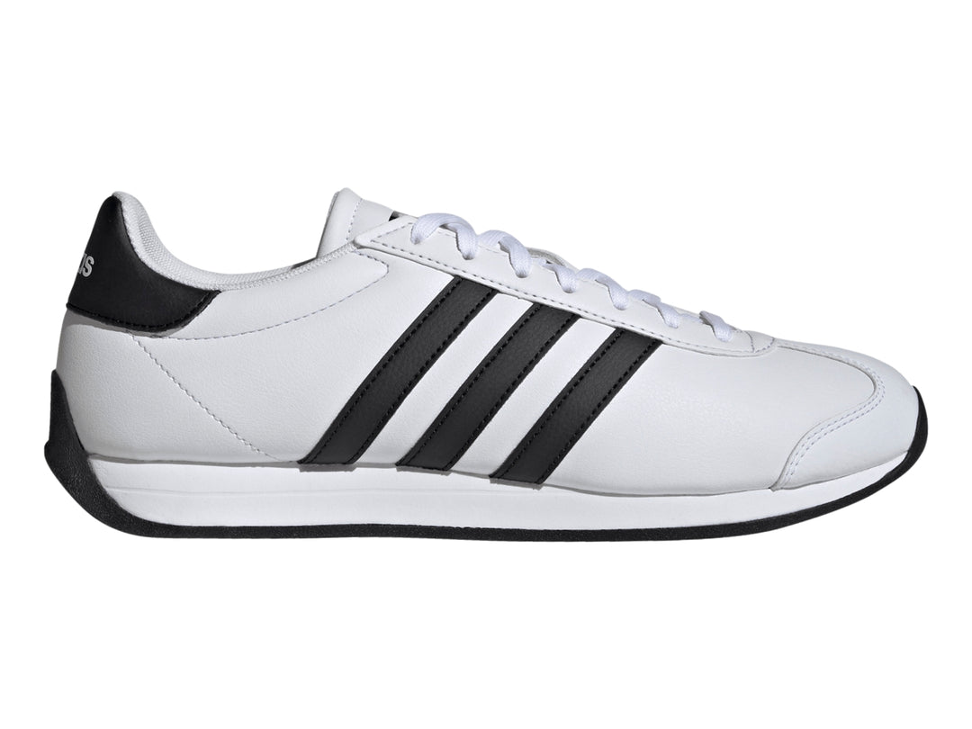 Tenis Adidas Runvist blancos con tres franjas negras laterales y suela negra.