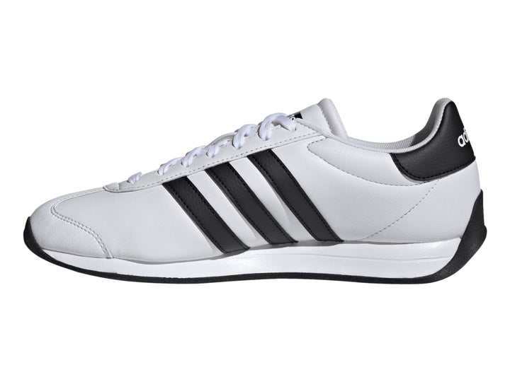 Tenis Adidas Runvist blancos con tres franjas negras laterales y suela negra.