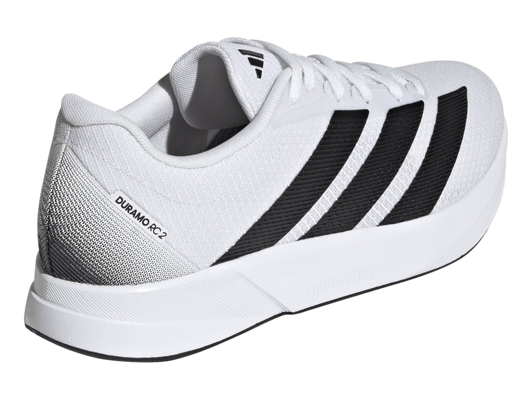 Tenis deportivos Adidas Duramo RC2 blancos con tres franjas negras laterales y suela blanca.