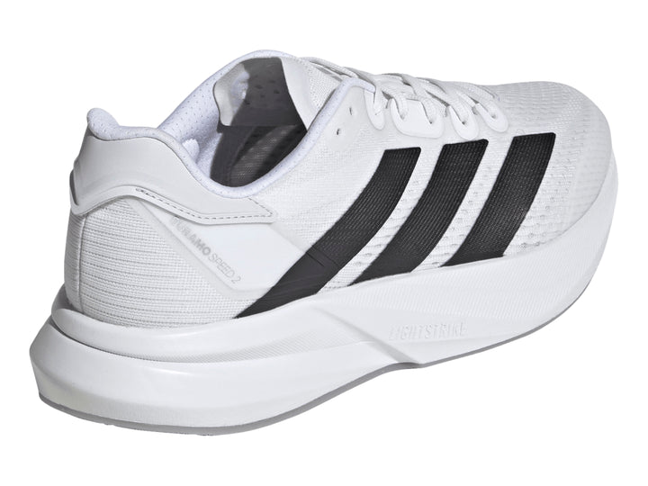 Tenis Adidas Duramo Speed 2 color blanco con tres franjas negras laterales y suela blanca.