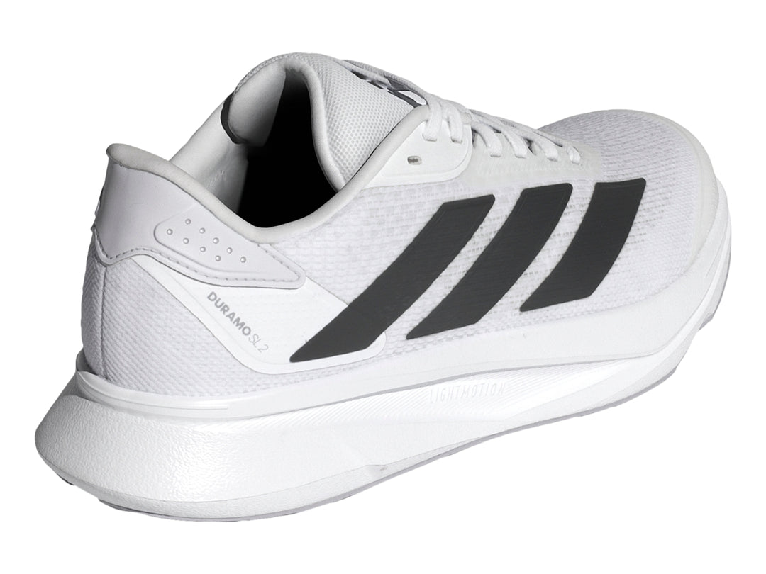 Tenis Adidas Duramo SL2 blancos con tres franjas negras laterales y suela blanca.