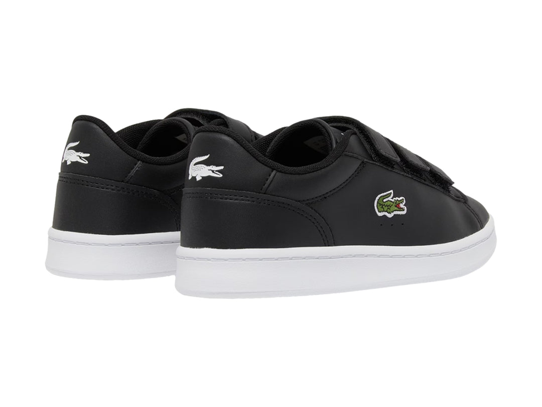 Tenis Lacoste Carnaby Set color negro con suela blanca y cierre de velcro.