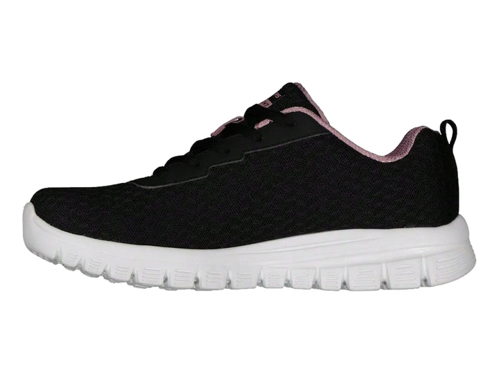 Tenis deportivos Skechers para mujer en color negro con suela blanca y detalles en rosa.