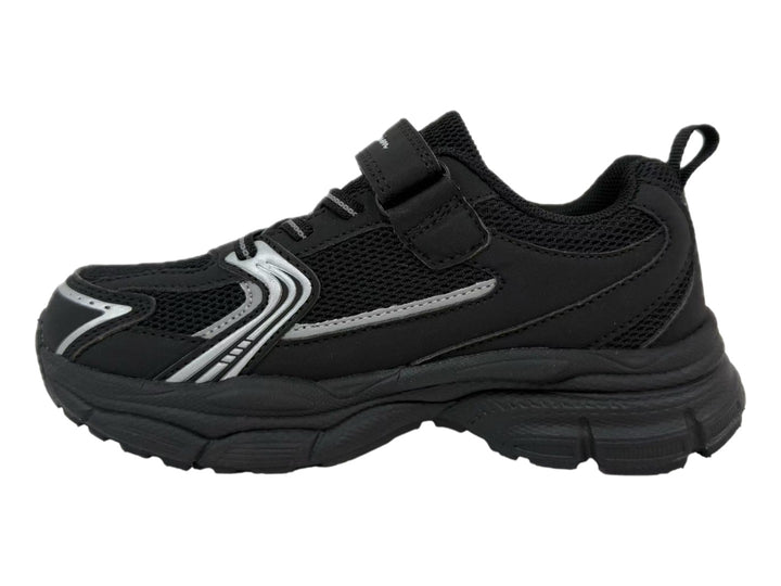 Tenis Champion Chrome Retro color negro con detalles plateados, suela gruesa y cierre de velcro.