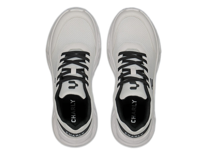 Tenis Charly Light Sport en color blanco con detalles y cordones en negro, vista lateral sobre fondo blanco.