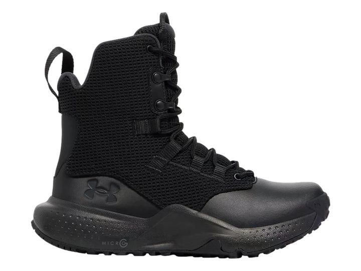 Bota Under Armour Micro G Stellar en color negro, con tejido transpirable y suela deportiva.