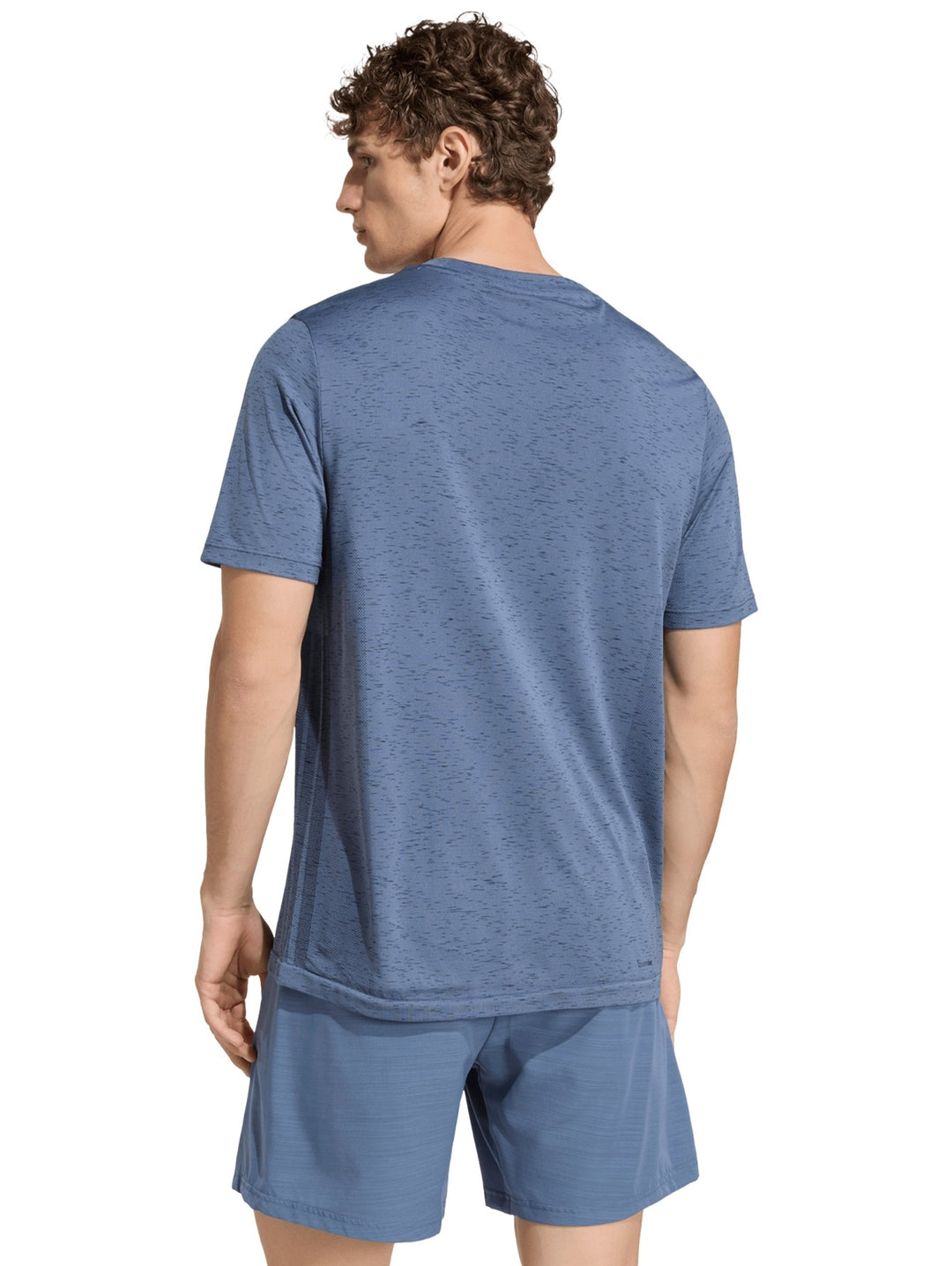 Hombre vistiendo playera y shorts deportivos Adidas en color azul prelov con logo en el pecho.