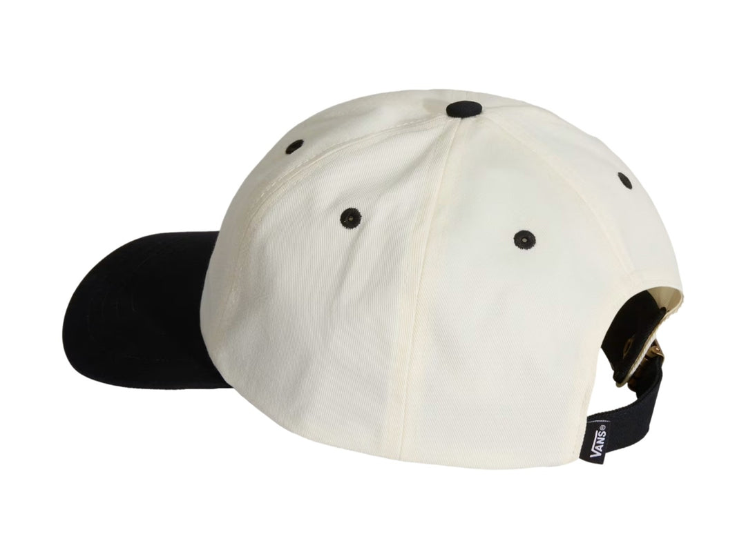 Gorra Vans blanca con visera negra y logotipo Lefty Script bordado en negro en el frente.