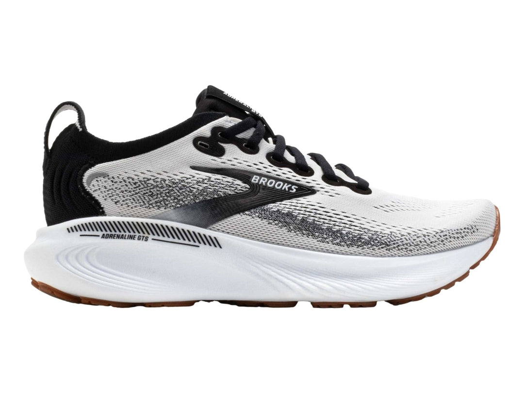Tenis Brooks Adrenaline GTS 25 en color blanco con detalles en negro y suela blanca y café.