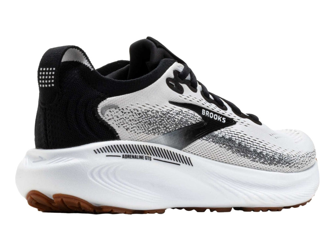 Tenis Brooks Adrenaline GTS 25 en color blanco con detalles en negro y suela blanca y café.
