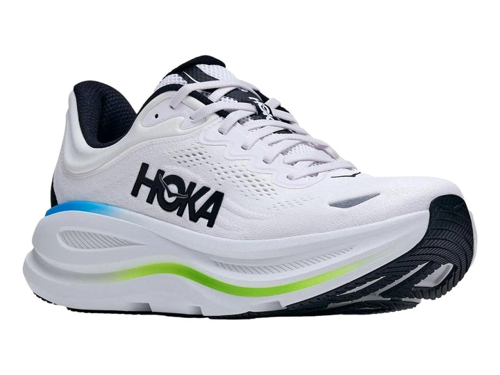 Tenis HOKA Bondi 9 color blanco con detalles en azul y verde neón y suela blanca gruesa